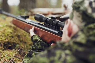 Image showing soldier or hunter shooting with gun in forest