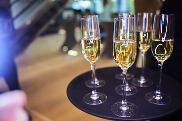 Image showing Full glasses of Champagne on tray