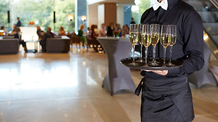 Image showing Waiter serving champagne on a tray