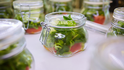 Image showing vegetable salad in glass jar on white background