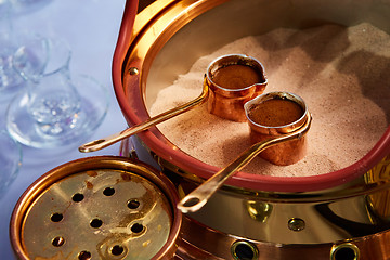 Image showing Preparation of Turkish coffee in the cezve in the sand at cafe bar