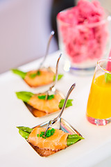 Image showing Appetizer plate of sauteed asparagus wrapped in thin slices smoked salmon