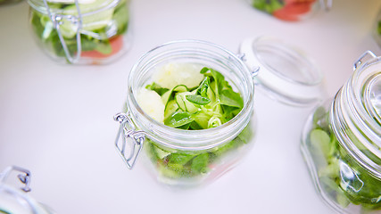 Image showing vegetable salad in glass jar on white background