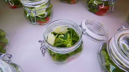 Image showing vegetable salad in glass jar on white background