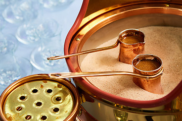 Image showing Preparation of Turkish coffee in the cezve in the sand at cafe bar