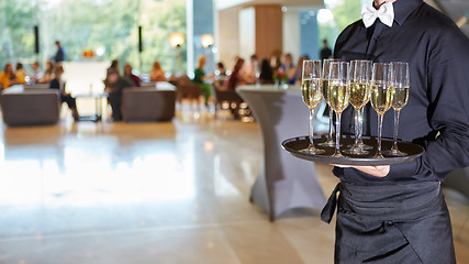 Image showing Waiter serving champagne on a tray