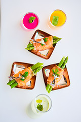 Image showing Appetizer plate of sauteed asparagus wrapped in thin slices smoked salmon