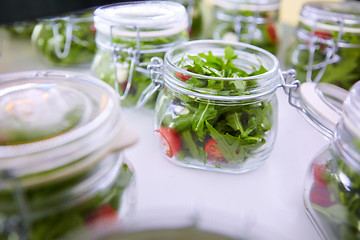 Image showing vegetable salad in glass jar on white background