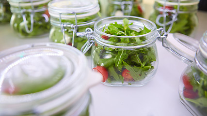 Image showing vegetable salad in glass jar on white background