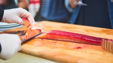 Image showing chef cutting smoke salmon prepare for customer appetizer