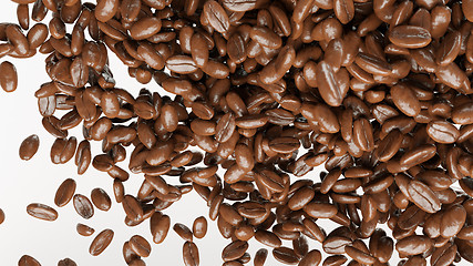 Image showing flying and mixing roasted coffee beans isolated