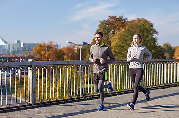 Image showing happy couple running outdoors