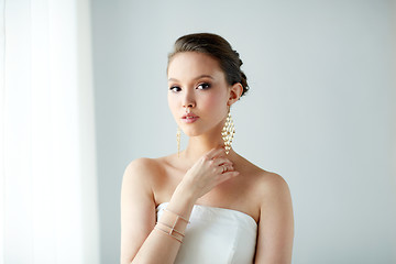 Image showing beautiful asian woman with earrings and bracelet