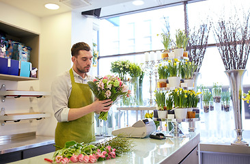 Image showing florist man making bunch at flower shop