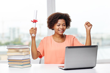 Image showing happy african woman with laptop, books and diploma