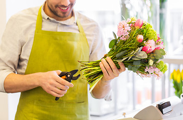 Image showing close up of florist man with flowers and pruner