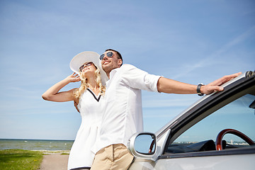 Image showing happy couple hugging near cabriolet car at sea