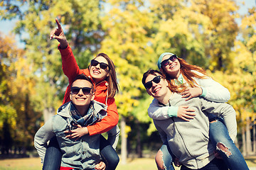 Image showing happy friends in shades having fun at autumn park