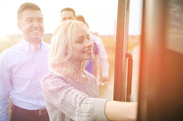 Image showing group of happy passengers boarding travel bus