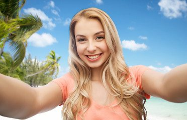 Image showing happy smiling young woman taking selfie
