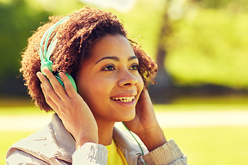 Image showing african woman in headphones listening to music