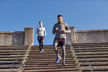 Image showing couple running downstairs in city