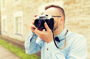 Image showing close up of hipster man with film camera in city