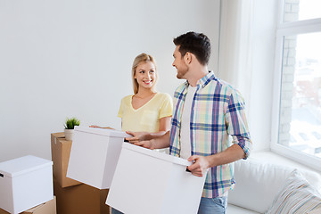 Image showing smiling couple with big boxes moving to new home