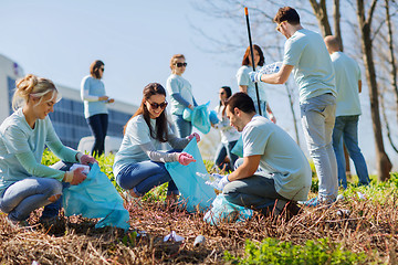 Image showing volunteers with garbage bags cleaning park area