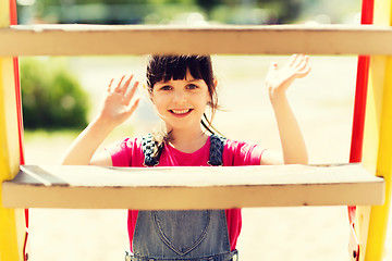 Image showing happy little girl climbing on children playground