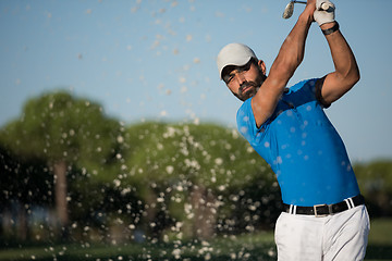 Image showing pro golfer hitting a sand bunker shot