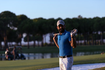 Image showing golfer  portrait at golf course on sunset