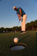 Image showing golfer  hitting shot at golf course