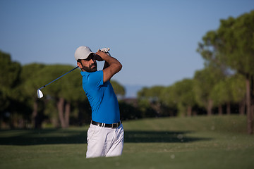 Image showing pro golfer hitting a sand bunker shot