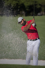 Image showing golfer hitting a sand bunker shot