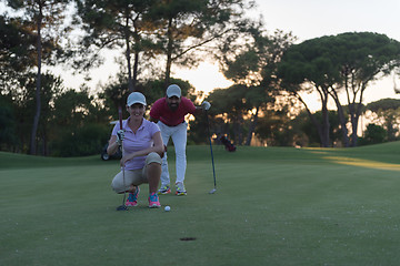 Image showing couple on golf course at sunset