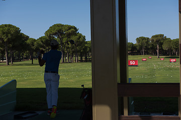 Image showing golf player practicing shot on training