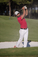 Image showing golfer hitting a sand bunker shot