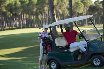 Image showing couple in buggy on golf course