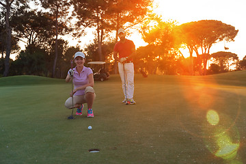 Image showing couple on golf course at sunset