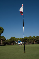 Image showing golf player aiming perfect  shot