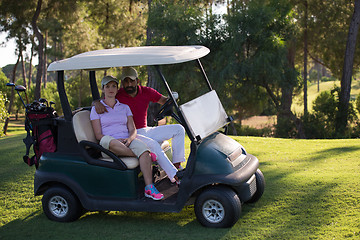 Image showing couple in buggy on golf course