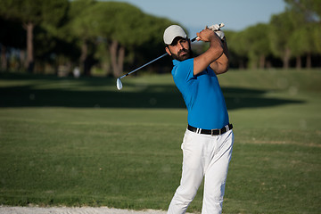 Image showing pro golfer hitting a sand bunker shot