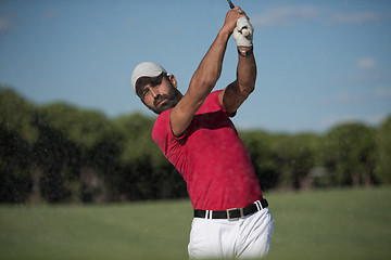 Image showing golfer hitting a sand bunker shot