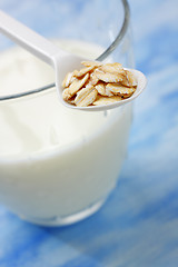 Image showing Plastic spoon filled with rolled oats