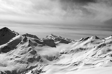 Image showing Black and white snowy mountains in evening