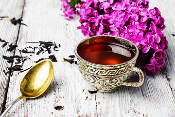 Image showing Still life with tea and branch of lilac