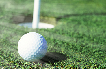 Image showing Golfball in front of the hole