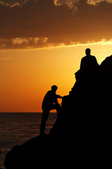 Image showing Two silhouette of people in beautiful sunset 
