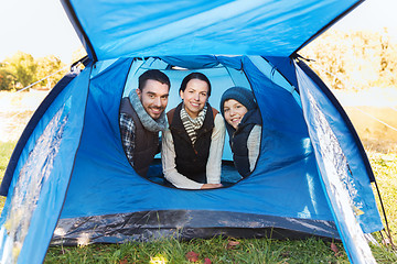 Image showing happy family with tent at camp site